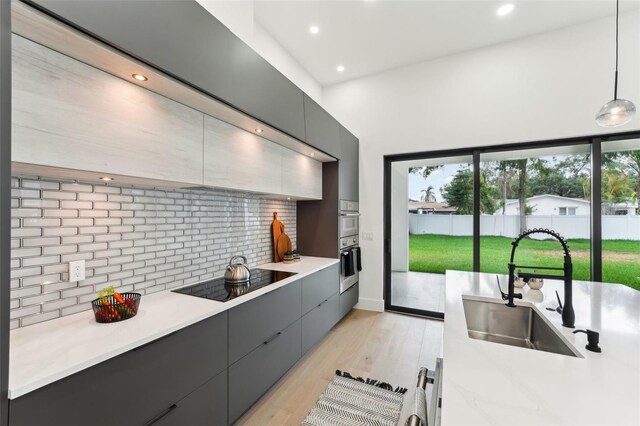 3817 W San Nicholas St, Tampa, FL 33629 - kitchen featuring oven, black electric stovetop, modern cabinets, gray cabinetry, and recessed lighting