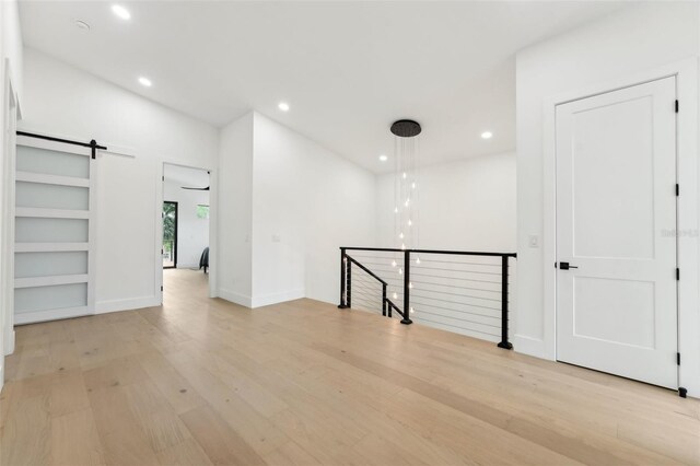 3817 W San Nicholas St, Tampa, FL 33629 - unfurnished room with light wood-style flooring, a barn door, and recessed lighting