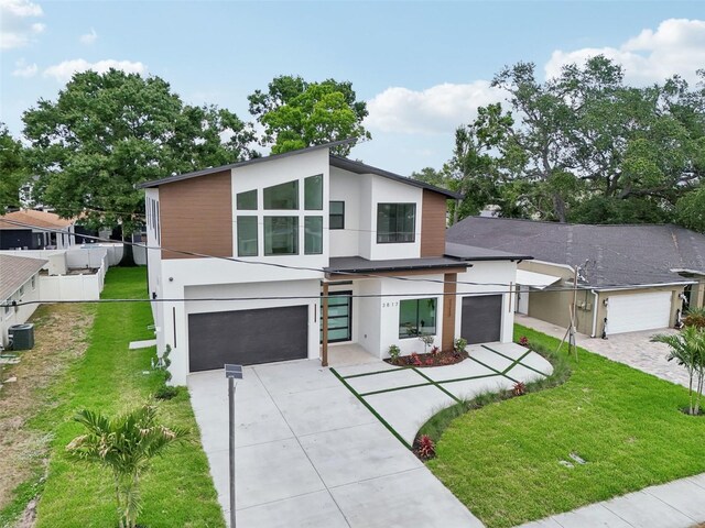 3817 W San Nicholas St, Tampa, FL 33629 - contemporary home with concrete driveway, stucco siding, and an attached garage