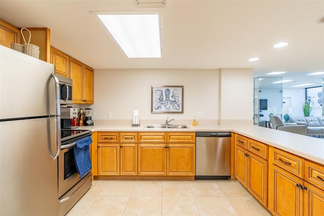 80 Rogers St Unit 6D, Clearwater, FL 33756 - kitchen with appliances with stainless steel finishes, a sink, light countertops, brown cabinets, and recessed lighting