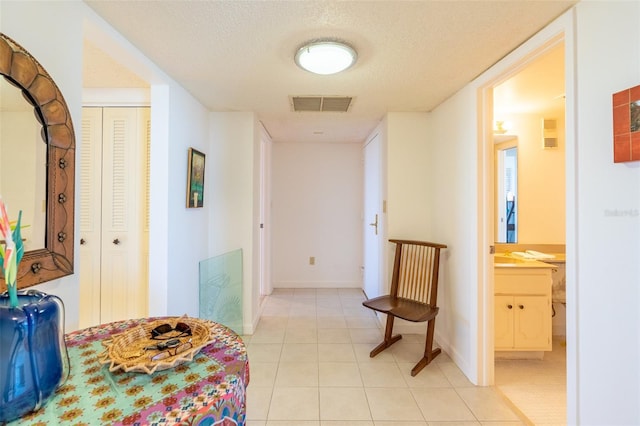 80 Rogers St Unit 6D, Clearwater, FL 33756 - hallway with light tile patterned floors, a textured ceiling, and baseboards