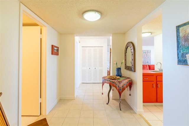 80 Rogers St Unit 6D, Clearwater, FL 33756 - corridor with a sink, a textured ceiling, light tile patterned floors, and baseboards
