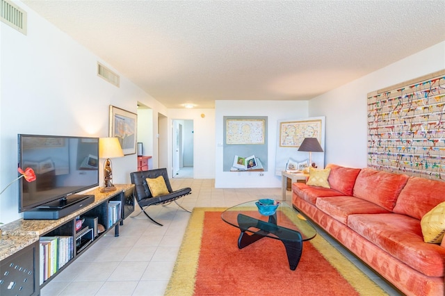 80 Rogers St Unit 6D, Clearwater, FL 33756 - living room with light tile patterned flooring and a textured ceiling