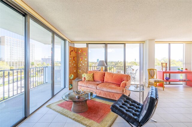 80 Rogers St Unit 6D, Clearwater, FL 33756 - sunroom featuring floor to ceiling windows, tile patterned floors, and a textured ceiling
