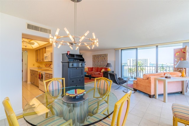 80 Rogers St Unit 6D, Clearwater, FL 33756 - dining space featuring light tile patterned floors and a chandelier