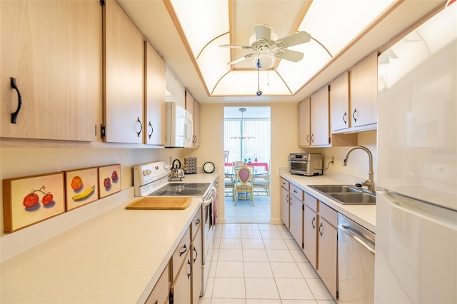 80 Rogers St Unit 6D, Clearwater, FL 33756 - kitchen featuring white appliances, a sink, light countertops, a ceiling fan, and light tile patterned floors