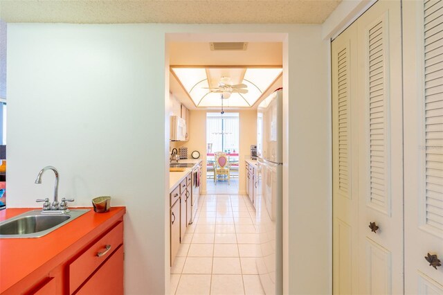 80 Rogers St Unit 6D, Clearwater, FL 33756 - kitchen featuring white appliances, a sink, and light tile patterned floors