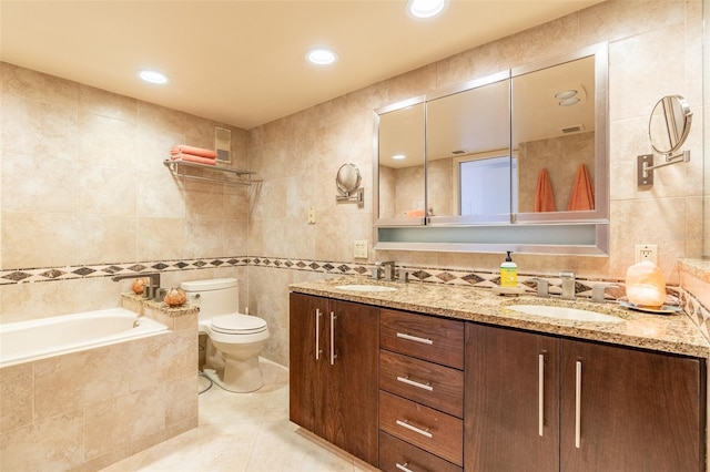 80 Rogers St Unit 6D, Clearwater, FL 33756 - full bath with tile walls, toilet, tile patterned flooring, tiled bath, and double vanity