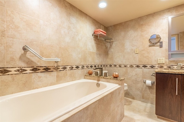 80 Rogers St Unit 6D, Clearwater, FL 33756 - bathroom with tile walls, toilet, tile patterned flooring, vanity, and recessed lighting