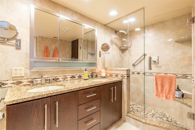 80 Rogers St Unit 6D, Clearwater, FL 33756 - bathroom with a stall shower, tile walls, double vanity, and recessed lighting