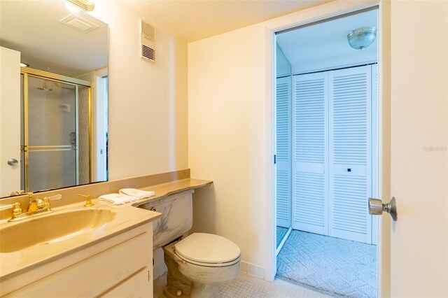 80 Rogers St Unit 6D, Clearwater, FL 33756 - full bathroom featuring a stall shower, vanity, tile patterned floors, and toilet