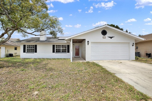8737 Beaver Ln, Port Richey, FL 34668 - ranch-style home featuring a chimney, solar panels, central AC, a garage, and brick siding