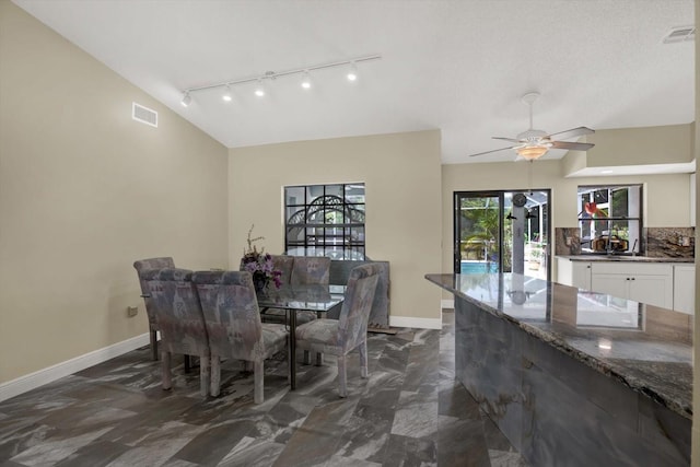 8737 Beaver Ln, Port Richey, FL 34668 - dining space with dark marble finish flooring, track lighting, baseboards, and ceiling fan