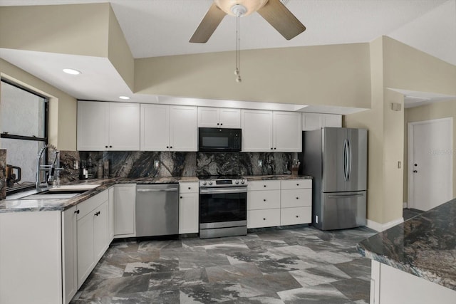 8737 Beaver Ln, Port Richey, FL 34668 - kitchen featuring appliances with stainless steel finishes, a sink, tasteful backsplash, ceiling fan, and dark stone countertops