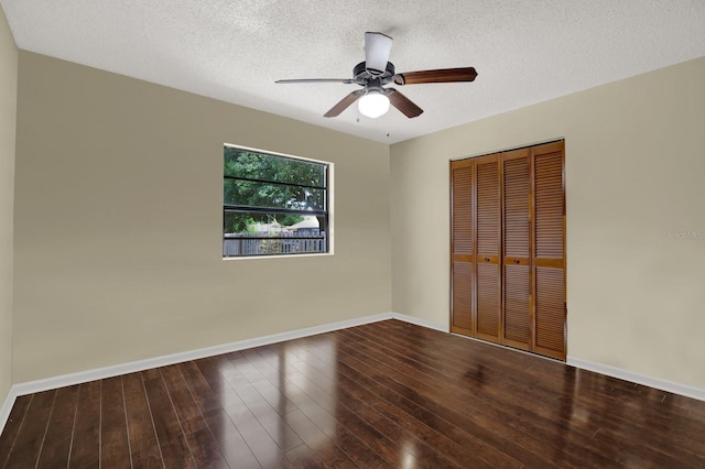 8737 Beaver Ln, Port Richey, FL 34668 - unfurnished bedroom featuring baseboards, a closet, wood finished floors, a textured ceiling, and a ceiling fan
