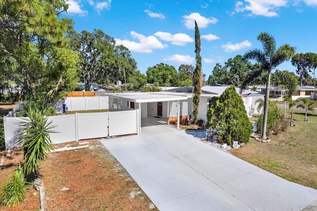 3501 63rd St N, Saint Petersburg, FL 33710 - view of front of home featuring concrete driveway, a carport, fence, and a gate