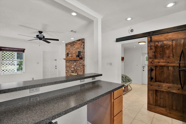 3501 63rd St N, Saint Petersburg, FL 33710 - kitchen with a barn door, a ceiling fan, light tile patterned floors, dark countertops, and recessed lighting