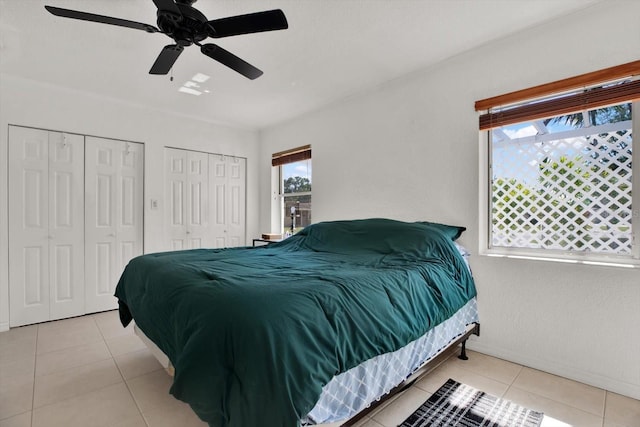 3501 63rd St N, Saint Petersburg, FL 33710 - tiled bedroom featuring multiple closets and a ceiling fan