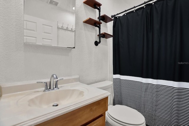 3501 63rd St N, Saint Petersburg, FL 33710 - bathroom with a textured wall, toilet, vanity, and a shower with curtain
