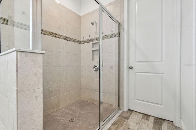 12710 Wheatgrass Ct, Parrish, FL 34219 - bathroom featuring a stall shower and wood finished floors