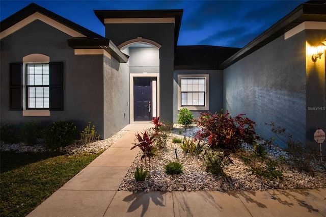 12710 Wheatgrass Ct, Parrish, FL 34219 - view of exterior entry with stucco siding