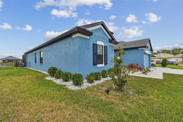 12710 Wheatgrass Ct, Parrish, FL 34219 - view of property exterior with an attached garage, stucco siding, central AC, and driveway