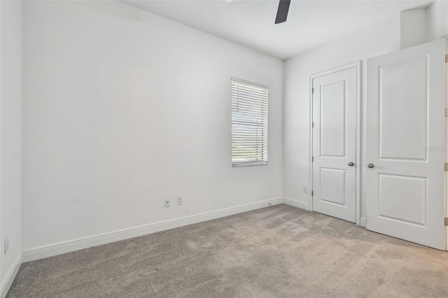 12710 Wheatgrass Ct, Parrish, FL 34219 - unfurnished bedroom featuring light carpet, baseboards, and a ceiling fan