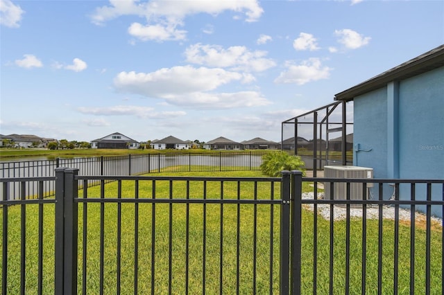12710 Wheatgrass Ct, Parrish, FL 34219 - view of yard with a water view, central AC, a residential view, and glass enclosure