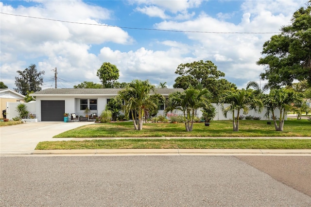 view of front facade featuring an attached garage, concrete driveway, and stucco siding