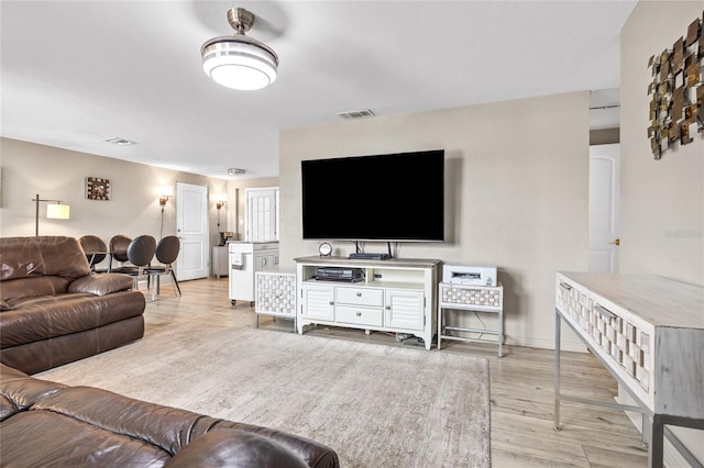 living room with light wood-type flooring and baseboards