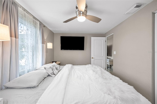 bedroom featuring multiple windows and a ceiling fan