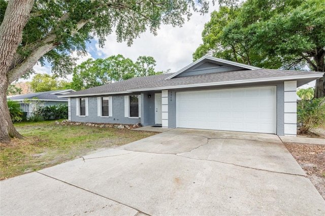 ranch-style house featuring stucco siding, driveway, roof with shingles, a garage, and a front yard