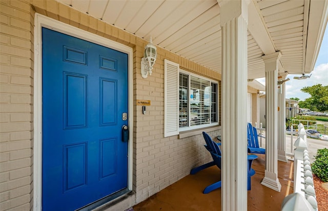 6111 2nd Ave, New Port Richey, FL 34653 - view of exterior entry featuring a porch and brick siding