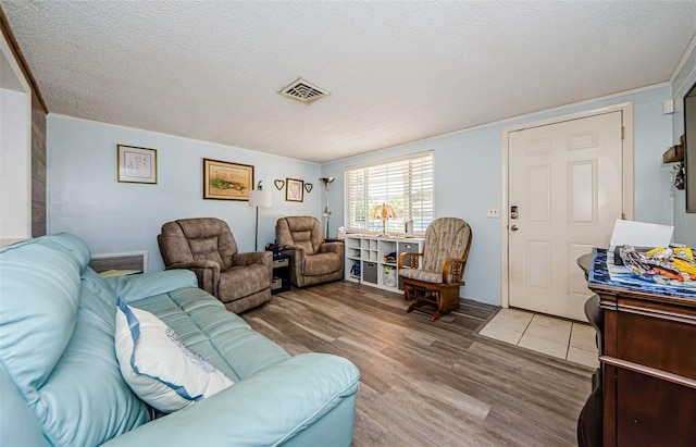 6111 2nd Ave, New Port Richey, FL 34653 - living room with light wood-style flooring and a textured ceiling