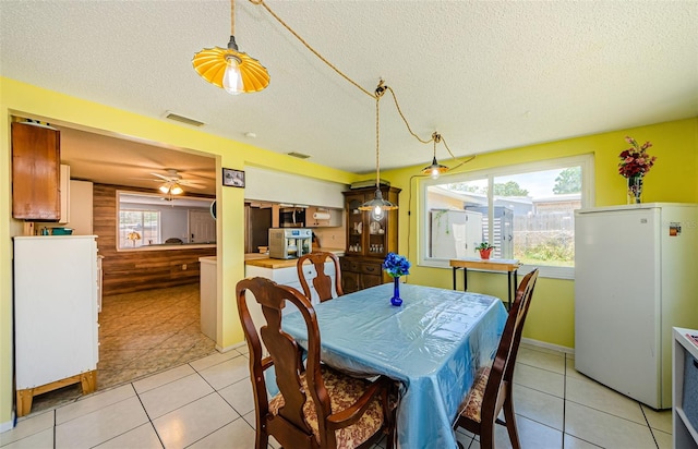 6111 2nd Ave, New Port Richey, FL 34653 - dining room with a textured ceiling, light tile patterned flooring, and a ceiling fan