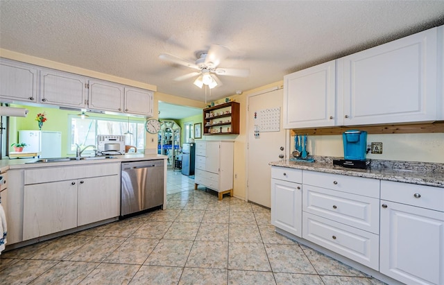 6111 2nd Ave, New Port Richey, FL 34653 - kitchen with stainless steel dishwasher, ceiling fan, a textured ceiling, white cabinetry, and light countertops