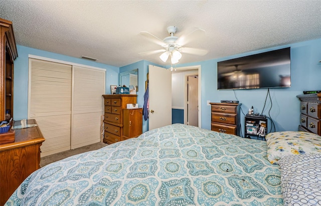 6111 2nd Ave, New Port Richey, FL 34653 - bedroom featuring a closet, carpet floors, a textured ceiling, and a ceiling fan