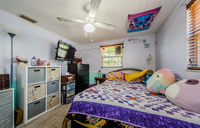 6111 2nd Ave, New Port Richey, FL 34653 - bedroom featuring carpet, a textured ceiling, and a ceiling fan