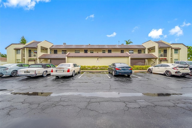 1100 E Bay Dr Unit 60, Largo, FL 33770 - view of front of property featuring uncovered parking and stucco siding