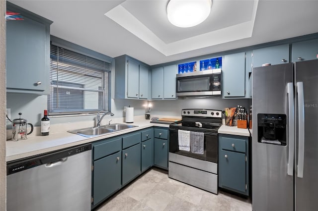 1100 E Bay Dr Unit 60, Largo, FL 33770 - kitchen featuring appliances with stainless steel finishes, a sink, a tray ceiling, and light countertops