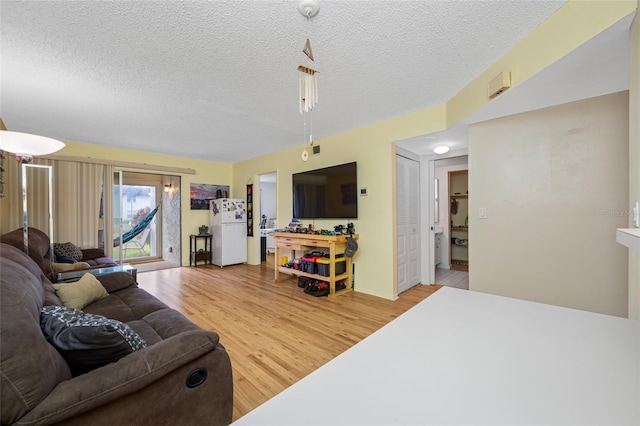 1100 E Bay Dr Unit 60, Largo, FL 33770 - living area with light wood-style flooring and a textured ceiling