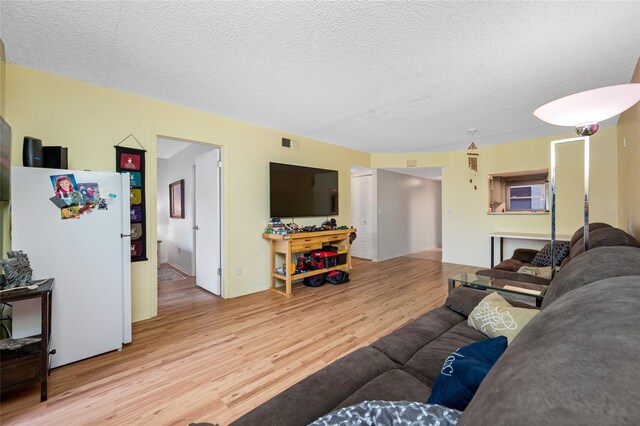 1100 E Bay Dr Unit 60, Largo, FL 33770 - living room featuring light wood-style floors and a textured ceiling