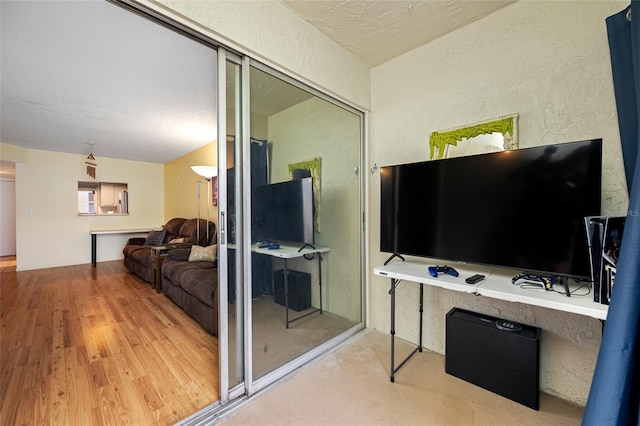 1100 E Bay Dr Unit 60, Largo, FL 33770 - living area with wood finished floors, a textured ceiling, and a textured wall