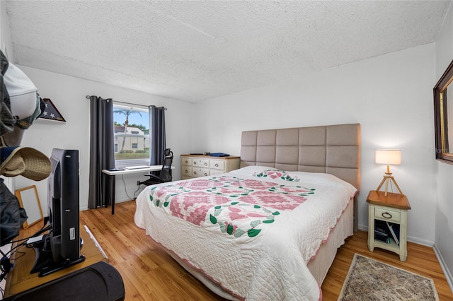 1100 E Bay Dr Unit 60, Largo, FL 33770 - bedroom with light wood-type flooring and a textured ceiling