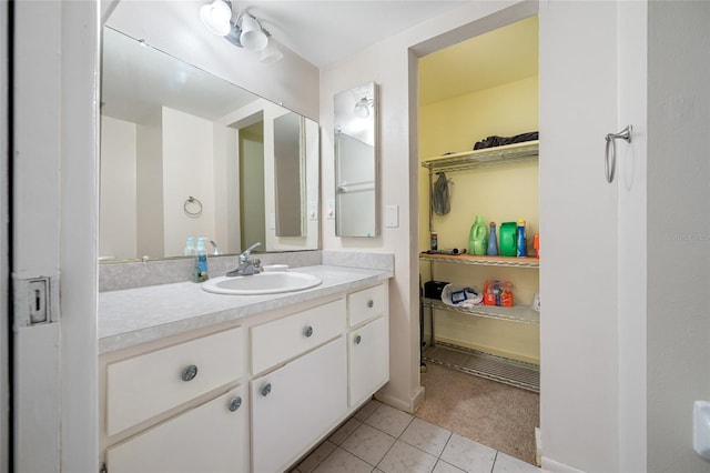 1100 E Bay Dr Unit 60, Largo, FL 33770 - bathroom featuring tile patterned floors, vanity, and a spacious closet