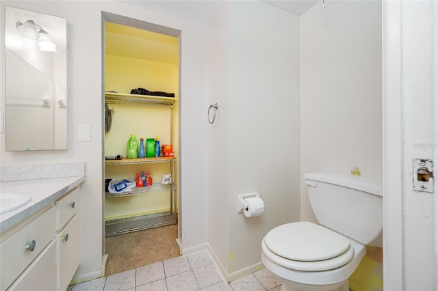 1100 E Bay Dr Unit 60, Largo, FL 33770 - bathroom featuring toilet, vanity, baseboards, and a spacious closet