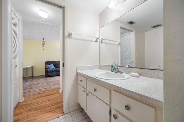 1100 E Bay Dr Unit 60, Largo, FL 33770 - bathroom with a closet, vanity, tile patterned flooring, and baseboards