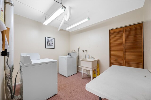 1100 E Bay Dr Unit 60, Largo, FL 33770 - washroom with separate washer and dryer, a sink, and light carpet