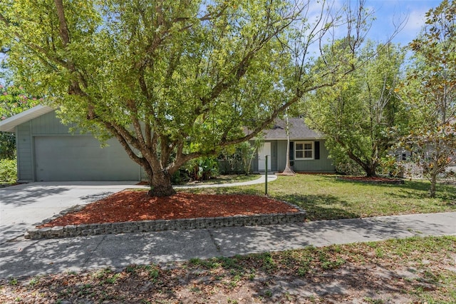 view of front facade with driveway, a front lawn, and an attached garage