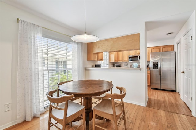 3205 W De Leon St Unit F, Tampa, FL 33609 - dining space with light wood finished floors and vaulted ceiling